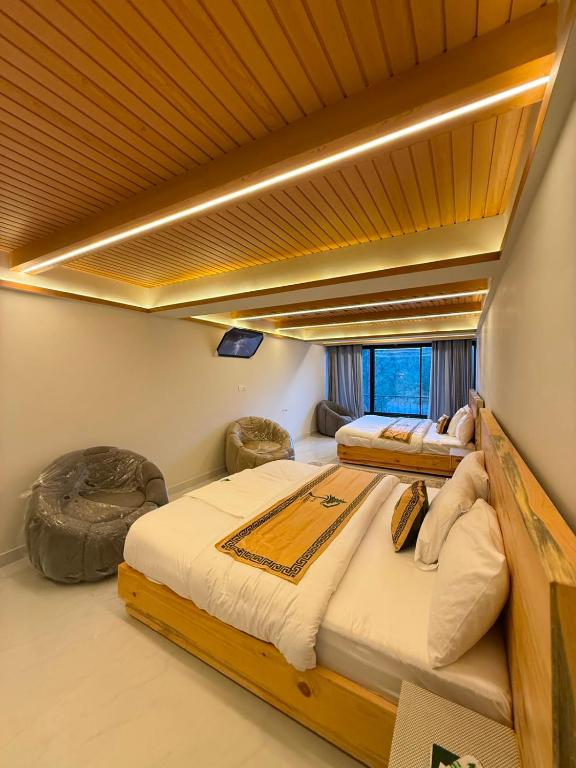 a bedroom with two beds on a boat at Pine View Hotel in Abbottabad