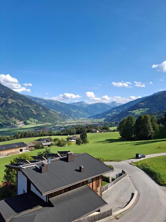 an overhead view of a house with mountains in the background at Ferienwohnung Kogler Zillertal in Fügenberg