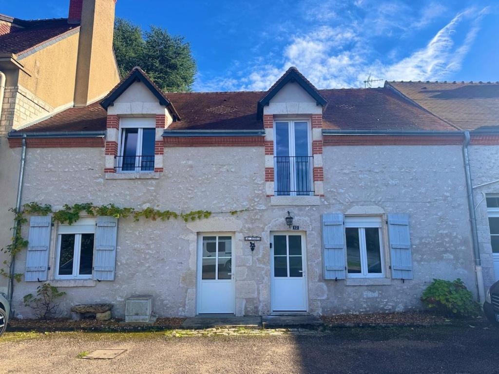 a brick house with white doors and windows at Maison d'Antan, Ambiance chevaleresque Cave voutée in Saint Laurent Nouan