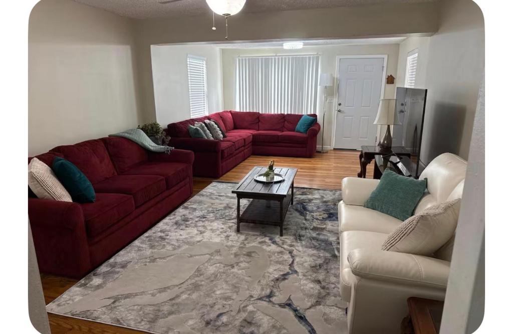 a living room with two red couches and a table at Rest apartment in Jacksonville