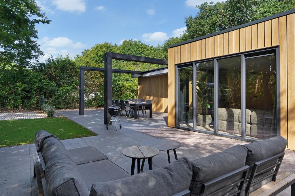 a patio with a couch and a table at Prinsenhof 10 - Ouddorp in Ouddorp
