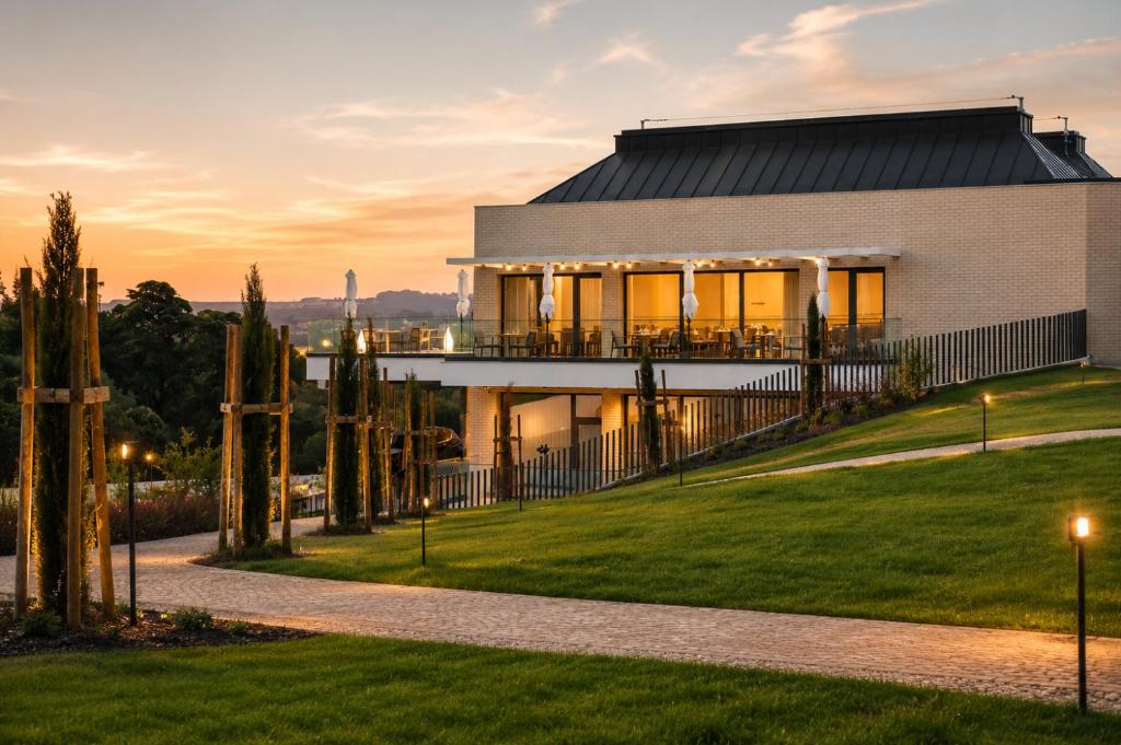 a house on a hill with a sunset at Quinta da Maquia Hotel in Sintra
