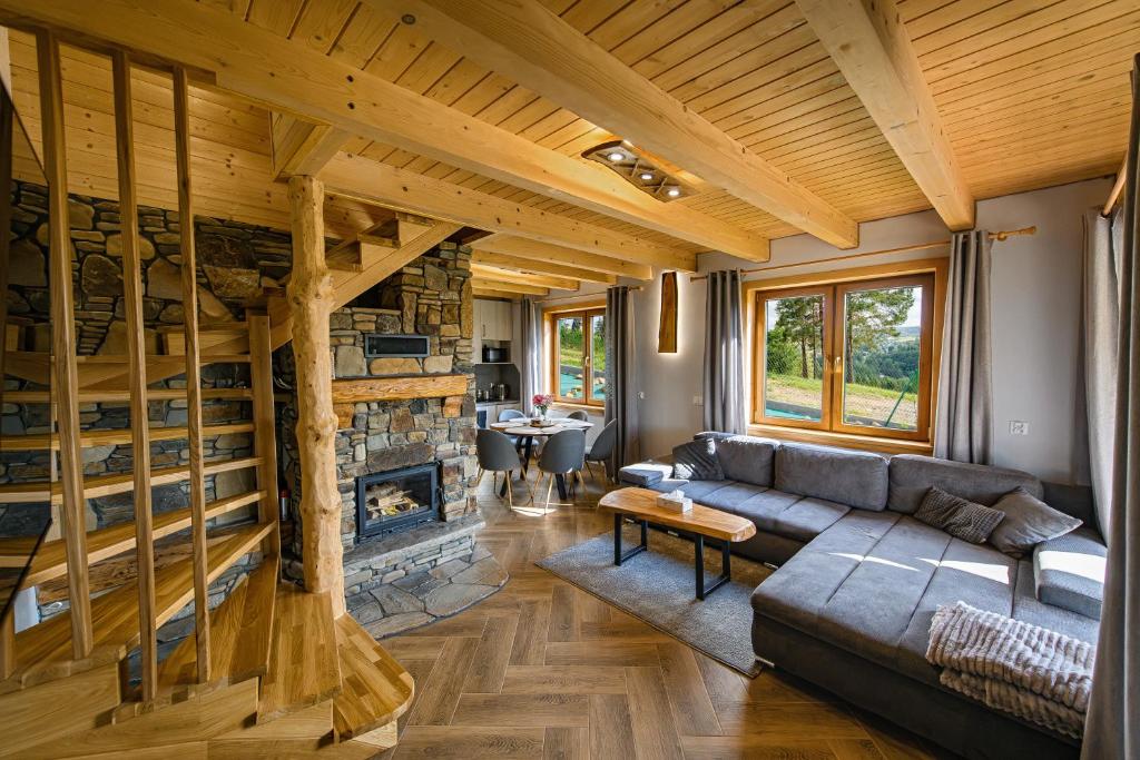a living room with a couch and a fireplace at Kamienny Horyzont in Bereżnica Wyżna