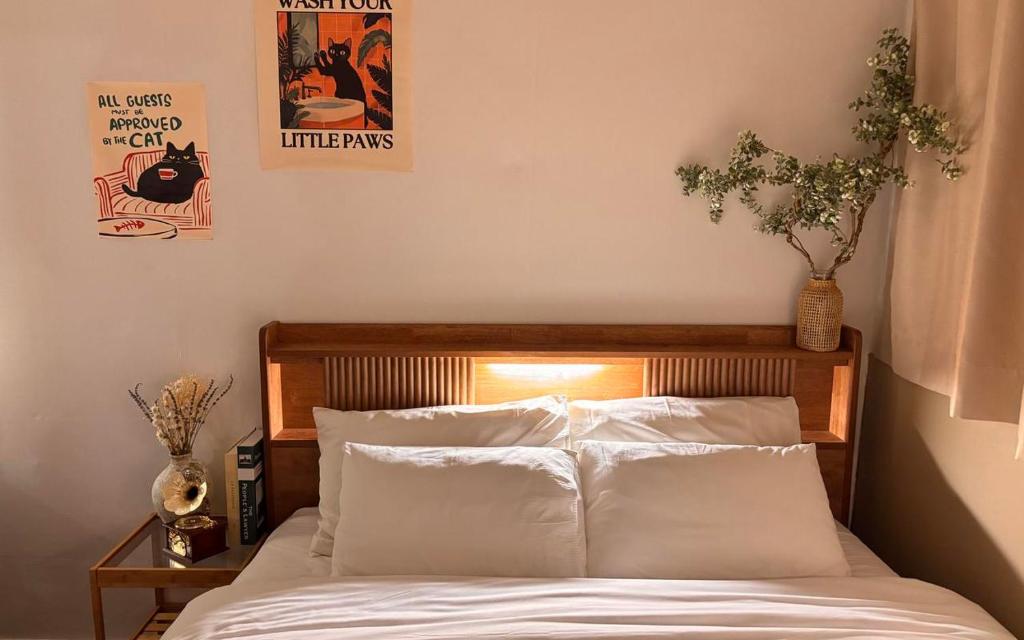 a bedroom with a bed with white pillows at Hotel AMY in Incheon