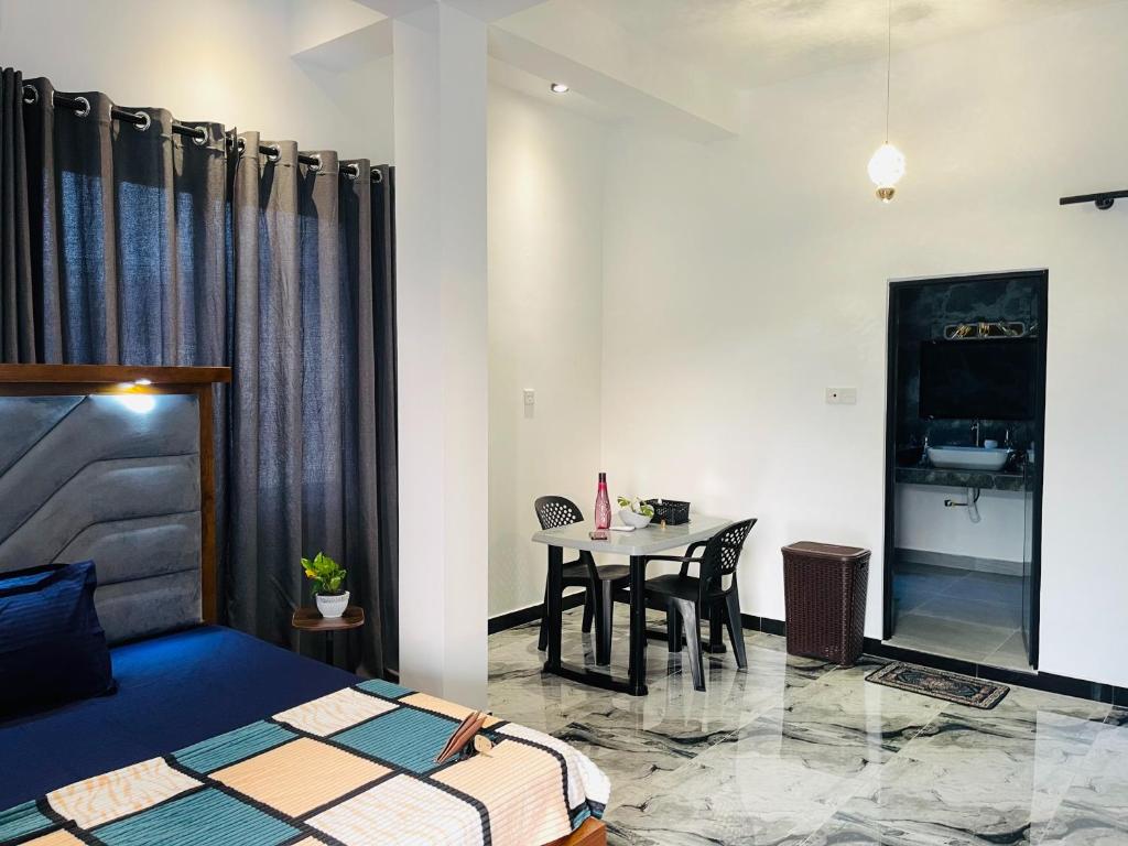 a bedroom with a bed and a table in a room at The Ocean Deck Apartments in Moragalla