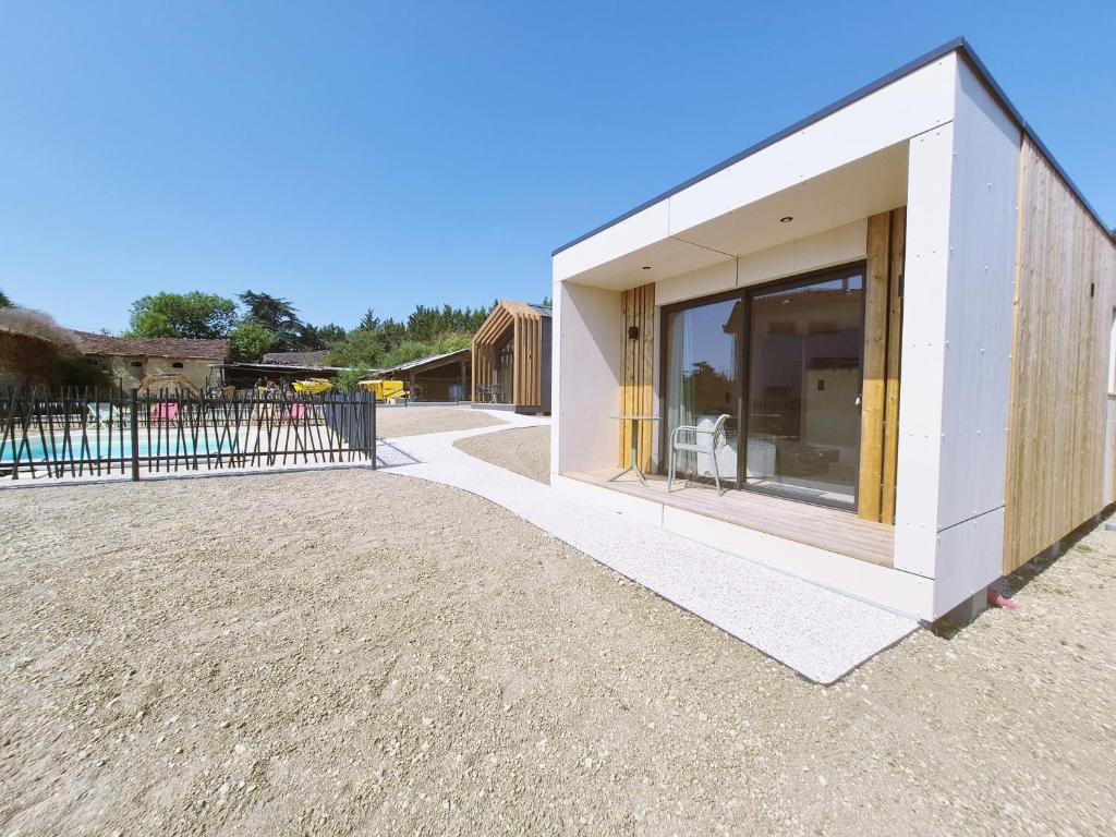 a building with a large window on the side of it at Filao - Clim Piscine in Auch