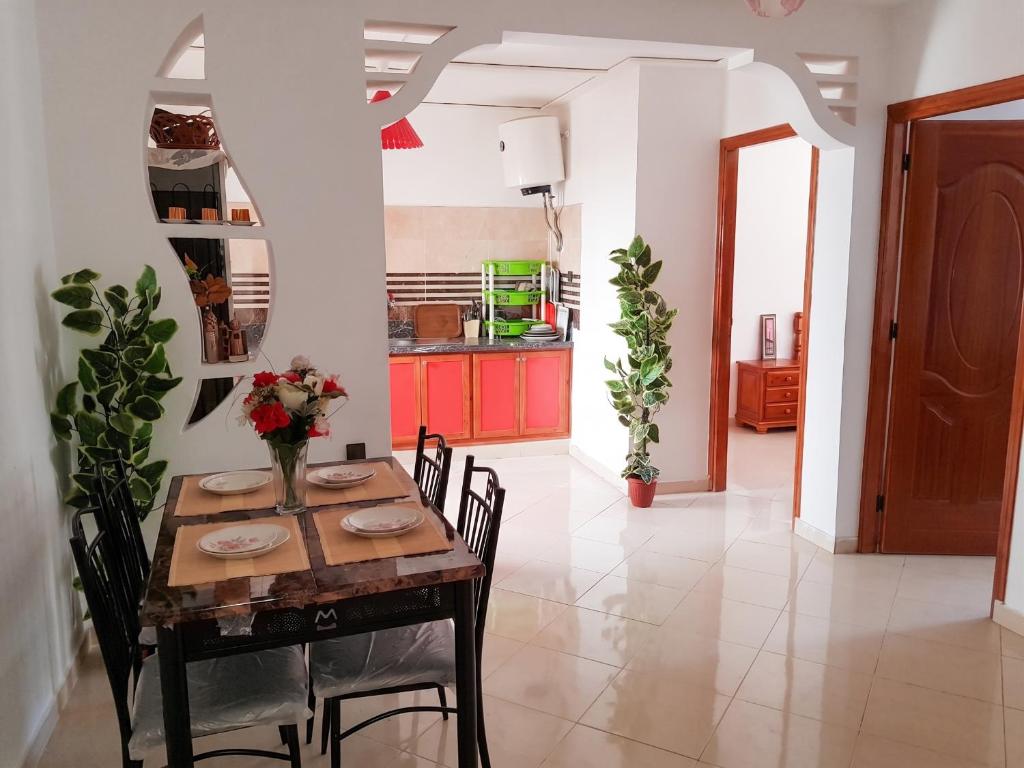 a kitchen and dining room with a table and chairs at Modern apartment near Oujda - 80 m² - 8 guests in Oujda