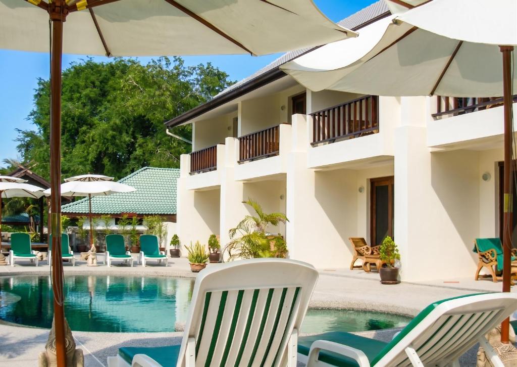 a resort with a pool and chairs and umbrellas at Cozy apartment in Ko Samui 64 m² with shared pool in Thong Son Beach