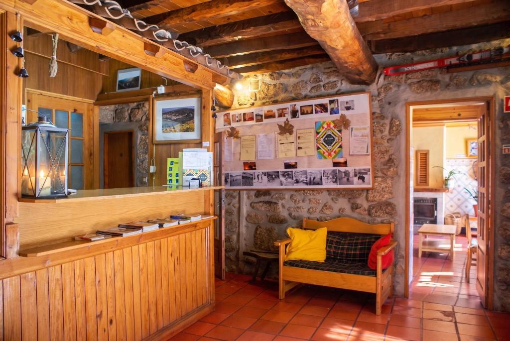 a restaurant with a bench in a room at Cosy Apartment Seia 25 m² Fireplace in Seia