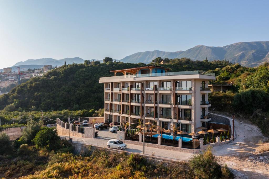 a building with a car parked in front of it at Hotel Potami in Himare