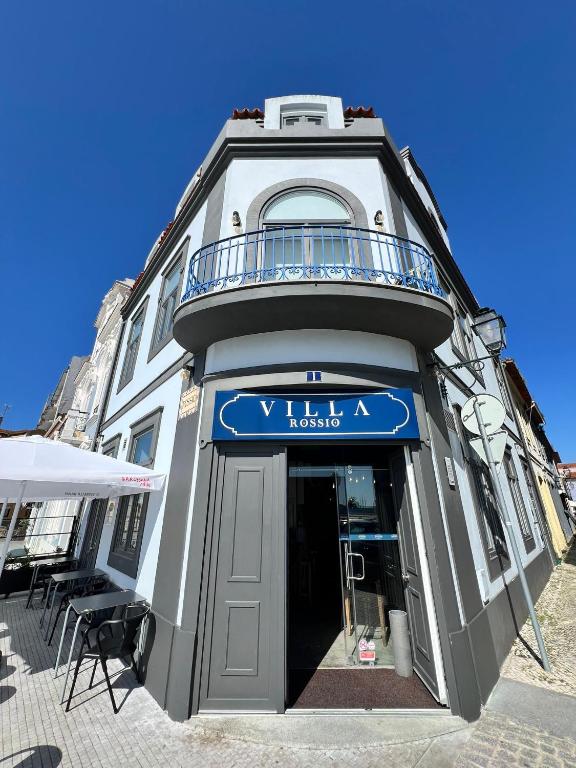 a building with a sign for a hotel at Villa Rossio in Aveiro