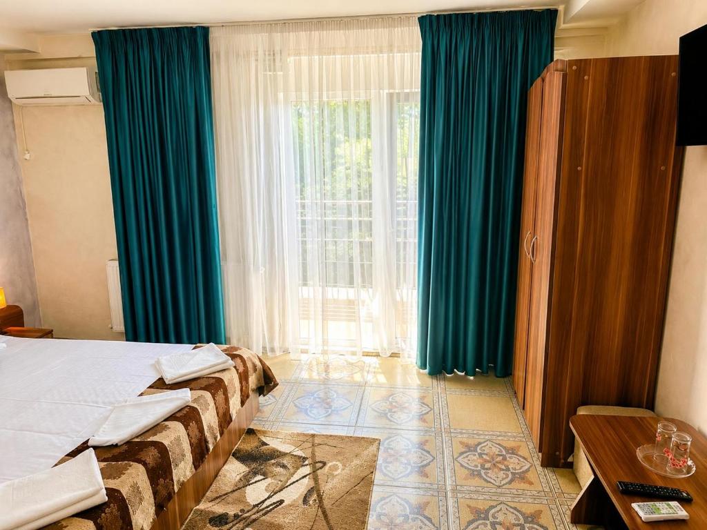 a hotel room with a bed and a large window at Casa Yva Black Sea in Venus