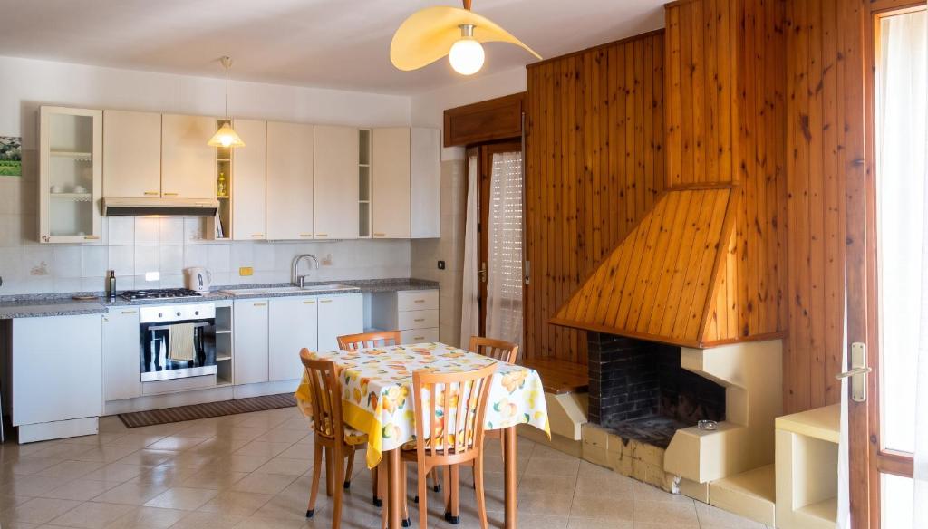 a kitchen with a table and a fireplace at Charming Apartment in Velina, 90 m², Mountain View in Castelnuovo Cilento