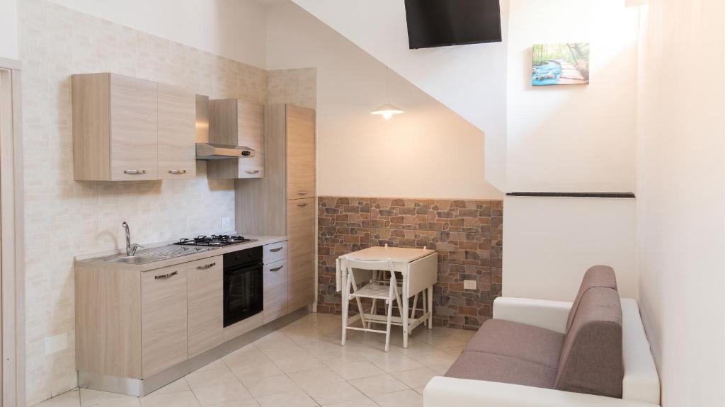 a small kitchen with a sink and a table at Charming studio with air conditioning in Gragnano - 35 sqm in Gragnano