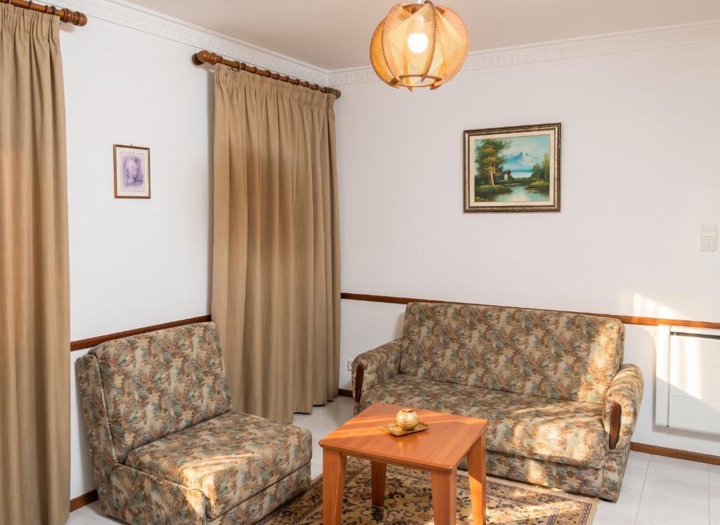 a living room with a couch and a chair at Charming Apartment in Alvoco da Serra with Mountain View in Alvoco da Serra
