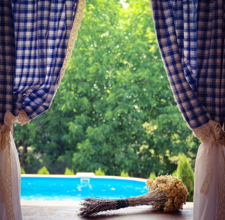 a window with a teddy bear sitting on a window sill at Elegant villa with jacuzzi near Možđenec in Možđenec