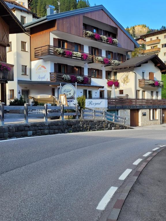 a building with balconies on the side of a road at Hotel Garni Royal in Arabba