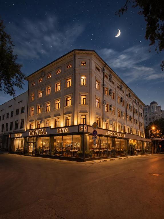 a building at night with a crescent moon above it at Grand Capital Hotel in Tashkent