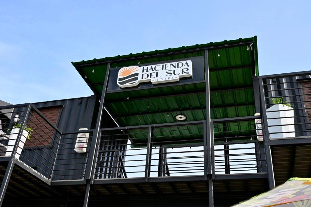 a building with a sign on the side of it at Hacienda del Sur in Santa Isabel