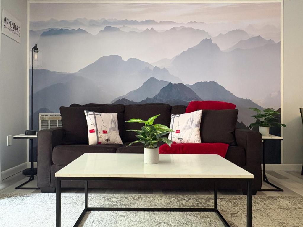 a living room with a couch with a mountain mural at Killington resort: Walk to Mountain, Biking & Pool in Killington