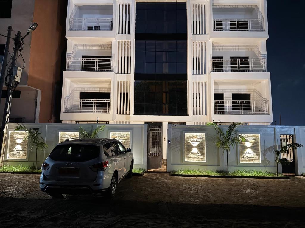 a car parked in front of a building at night at Le Conviviall in Yaoundé