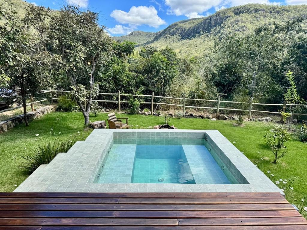a swimming pool in the middle of a yard at Arandu Bangalô in Cavalcante