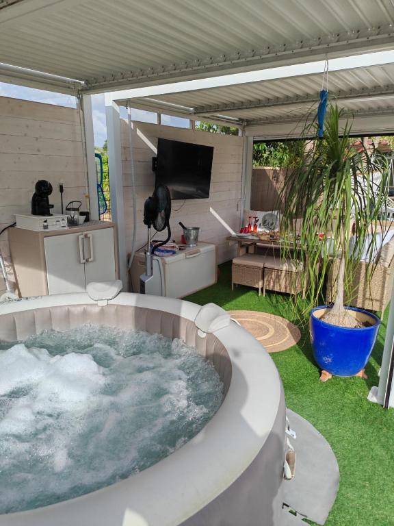 a hot tub in a yard with a patio at Villa Shiva Cerveteri, Casa Vacanze con SPA e Idromassaggio, Relax a due passi da Roma in Cerveteri