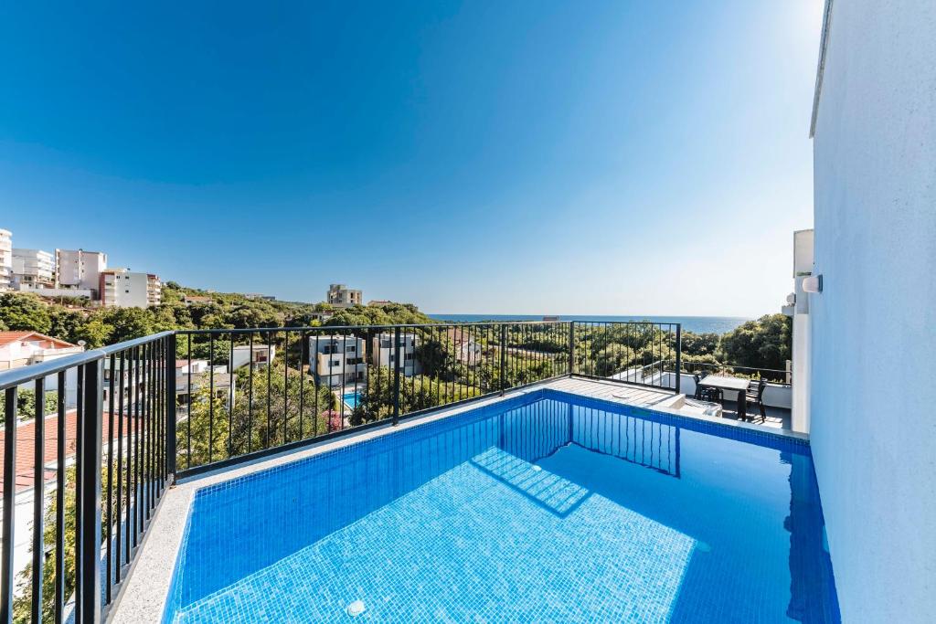 a swimming pool on the balcony of a building at Villa & Pool in Utjeha