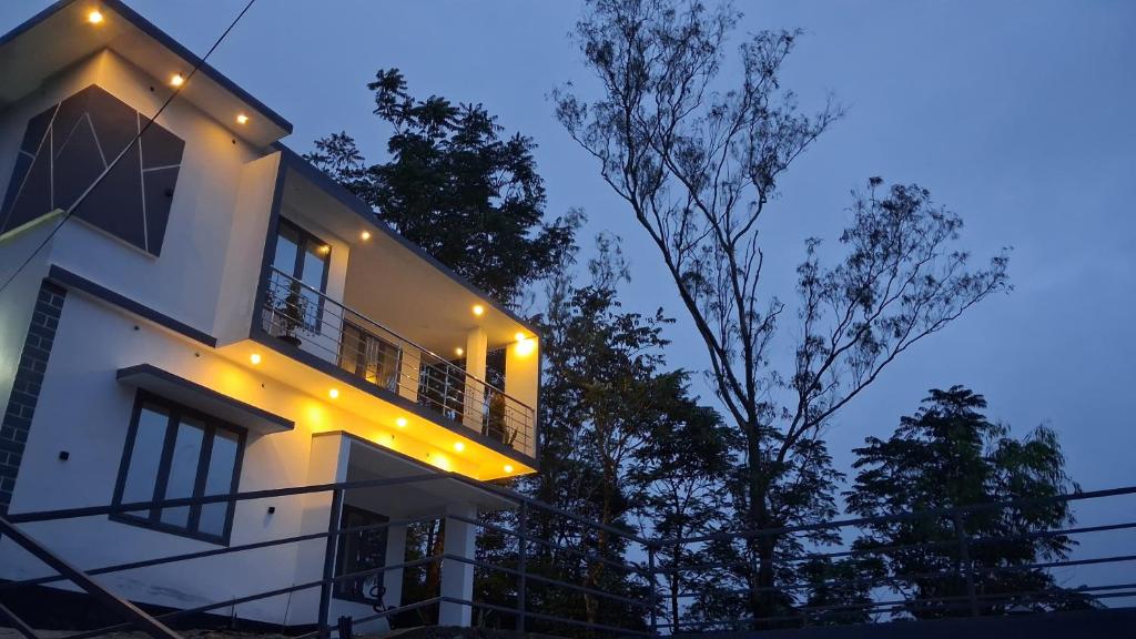 a white house with lights on it at night at Venus Valley Vagamon in Vagamon