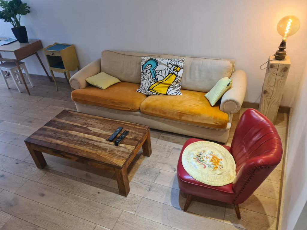 a living room with a couch and a coffee table at Le logis de la Fontaine in Ceyreste