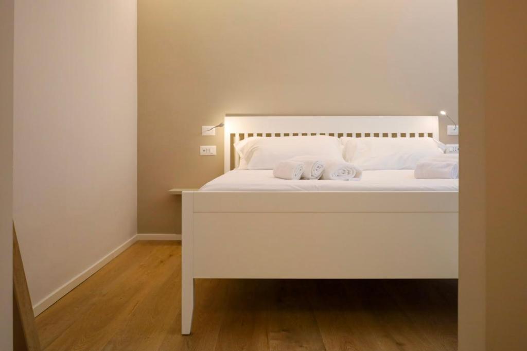 a white bed with two white pillows on it at Annina Locanda in Corciano