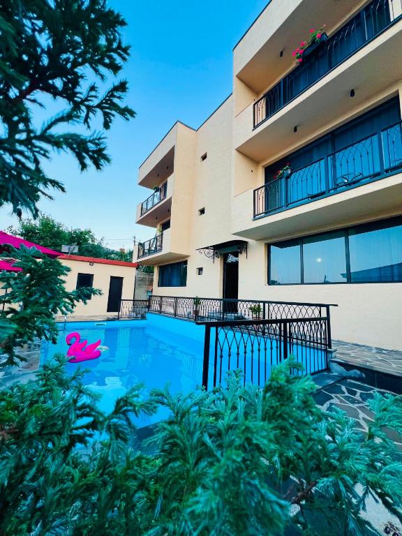 a swimming pool in front of a building at Horizont Boutique Hotel in Telavi