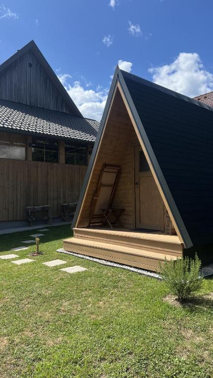 a small cabin with a door in a yard at Castle view Chalet - ZemvaStays in Zgornje Gorje