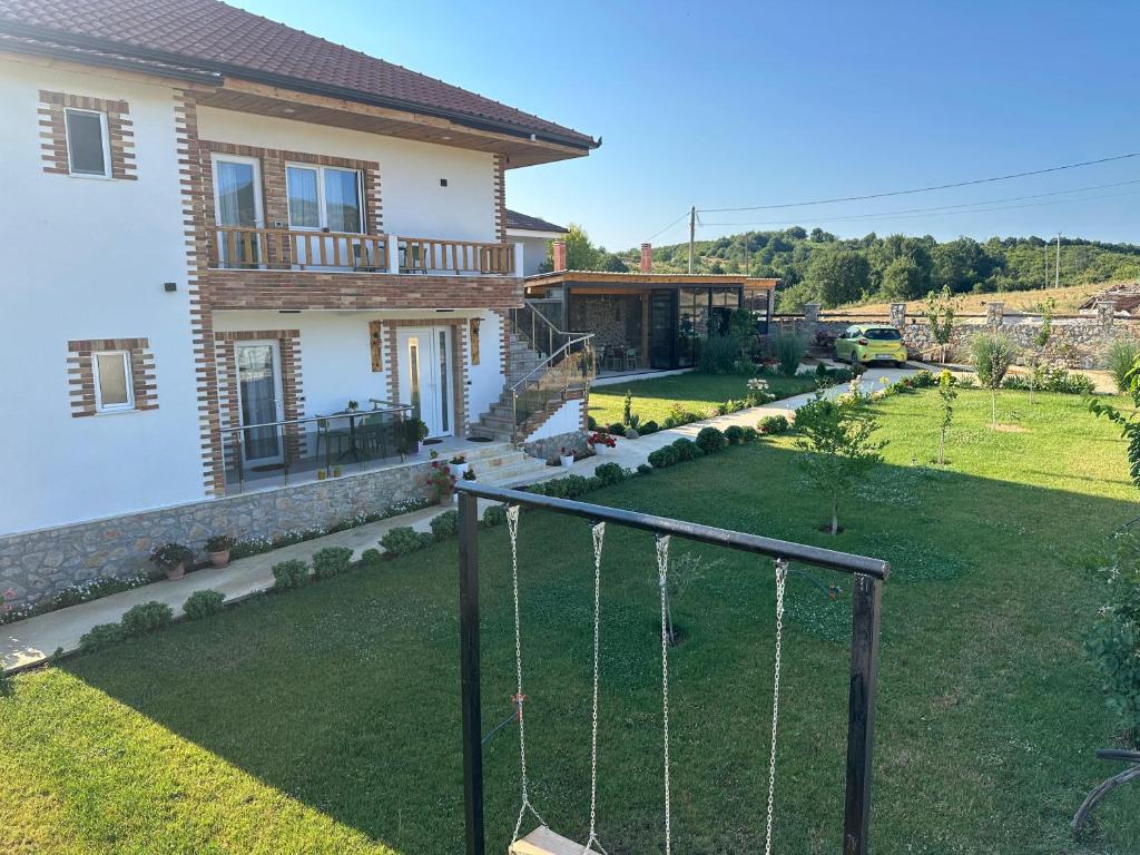a yard with a swing in front of a house at Mosaic Guesthouse in Lin