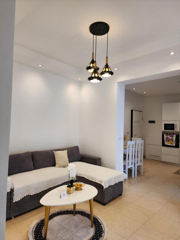 a living room with a couch and a table at Viola Apartments 2 Min to Beach in Vlorë