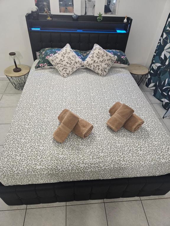 a bed with two brown pillows on it at Studio Centre Ville in Nice