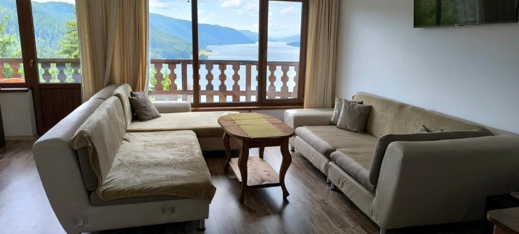 a living room with a couch and a table at EldoSport Hotel in Dospat