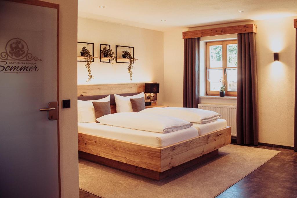 a bedroom with a wooden bed in a room at Pension Sommer in Waldsassen