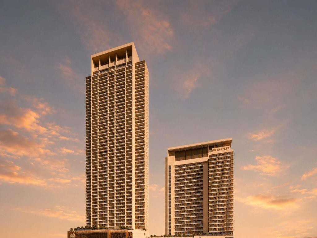 two tall buildings in front of a cloudy sky at Raffles Jeddah in Jeddah