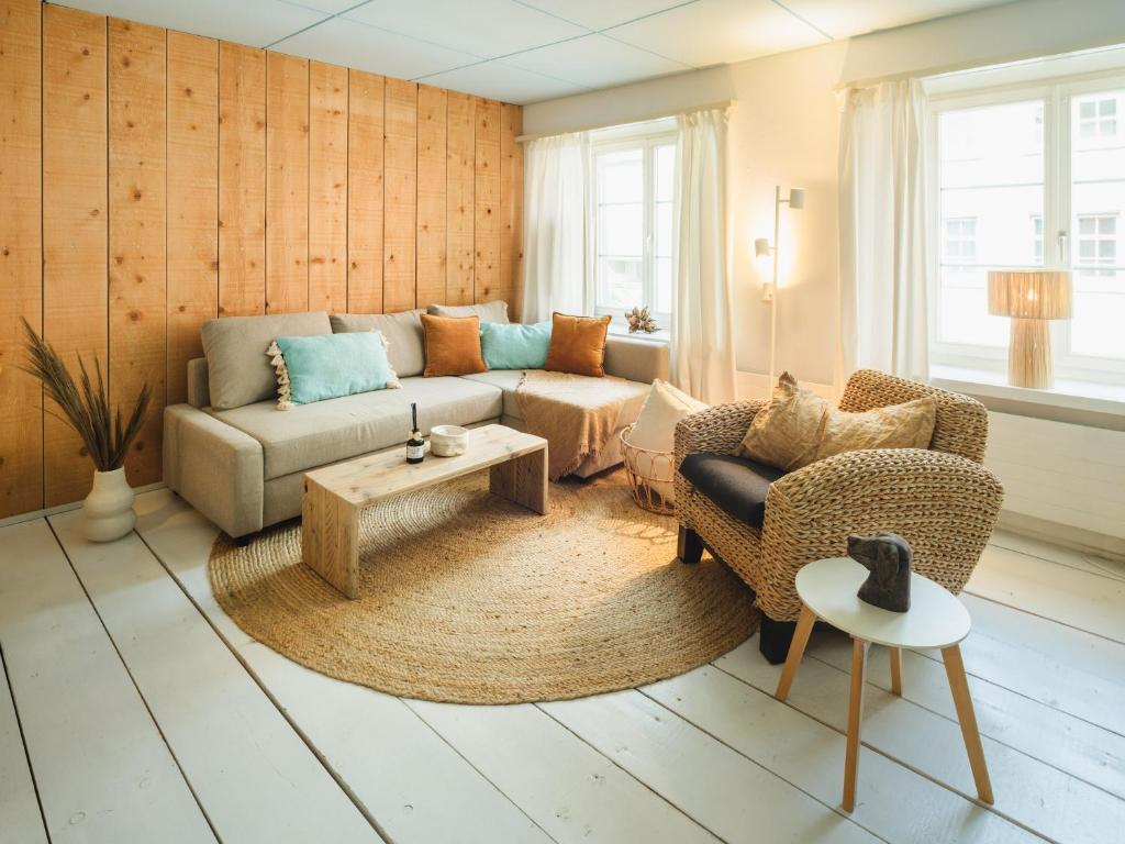 a living room with a couch and a table at Hygge Style Apartment in Steckborn