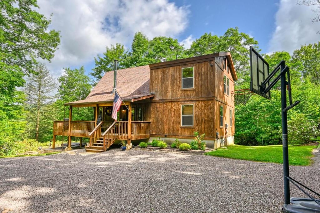 a large wooden house with a porch at Charming 4BR Cabin - HOT TUB - Mountain View in Hoyes Run