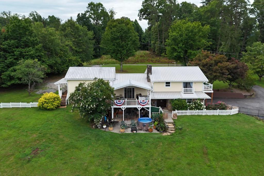 an aerial view of a white house with a yard at Mountain Forest Manor in Hiawassee