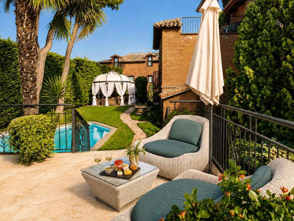 a patio with a gazebo and a chair and an umbrella at Hotel Boutique Real Casona De Las Amas in Azofra