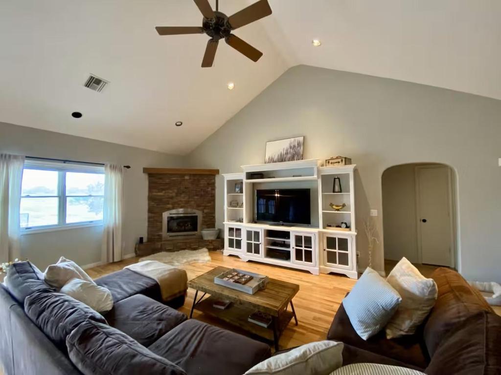 a living room with two couches and a tv at The Gathering Place home in Montrose