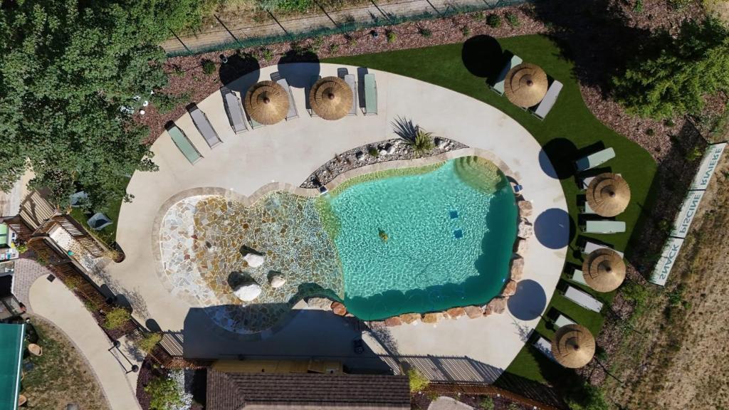an aerial view of a resort with a swimming pool at Le Valserine - Camping éco responsable in Chézery-Forens
