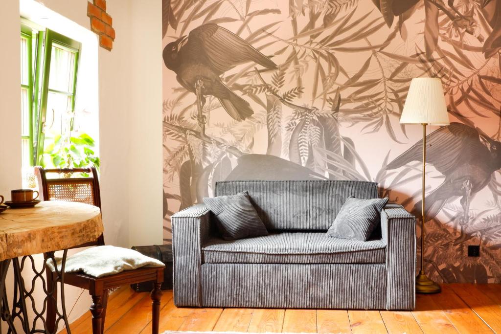 a living room with a couch and a wall mural at Wronki- mazurski spokój in Wronki