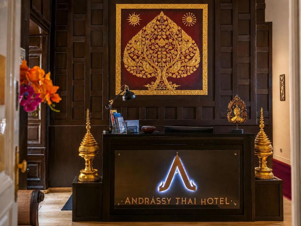 a sign on a tv in front of a hotel at Andrassy Thai Hotel in Budapest