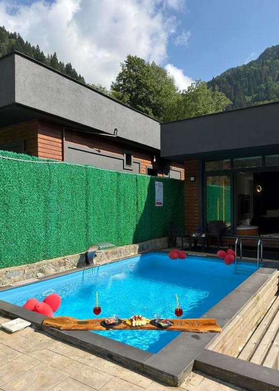 a swimming pool in the backyard of a house at Yesilvadi Otel 4M LUXURY in Ayder Yaylasi