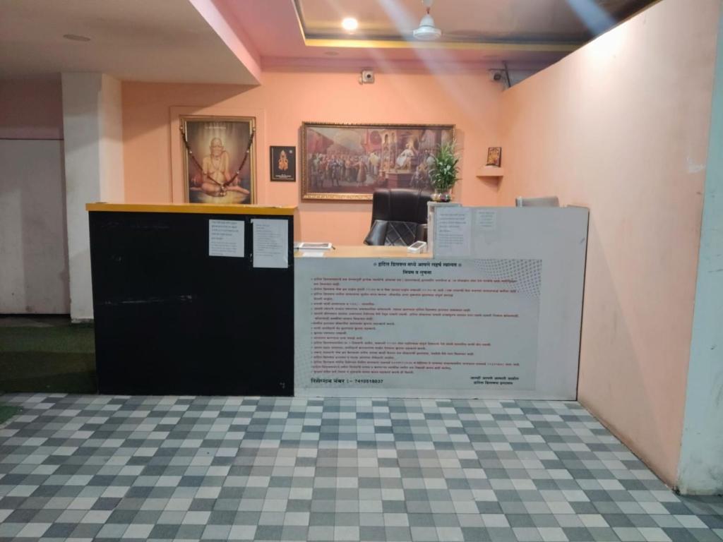 an office with a counter with a sign on the wall at Hotel Deluxe in Hinjewadi