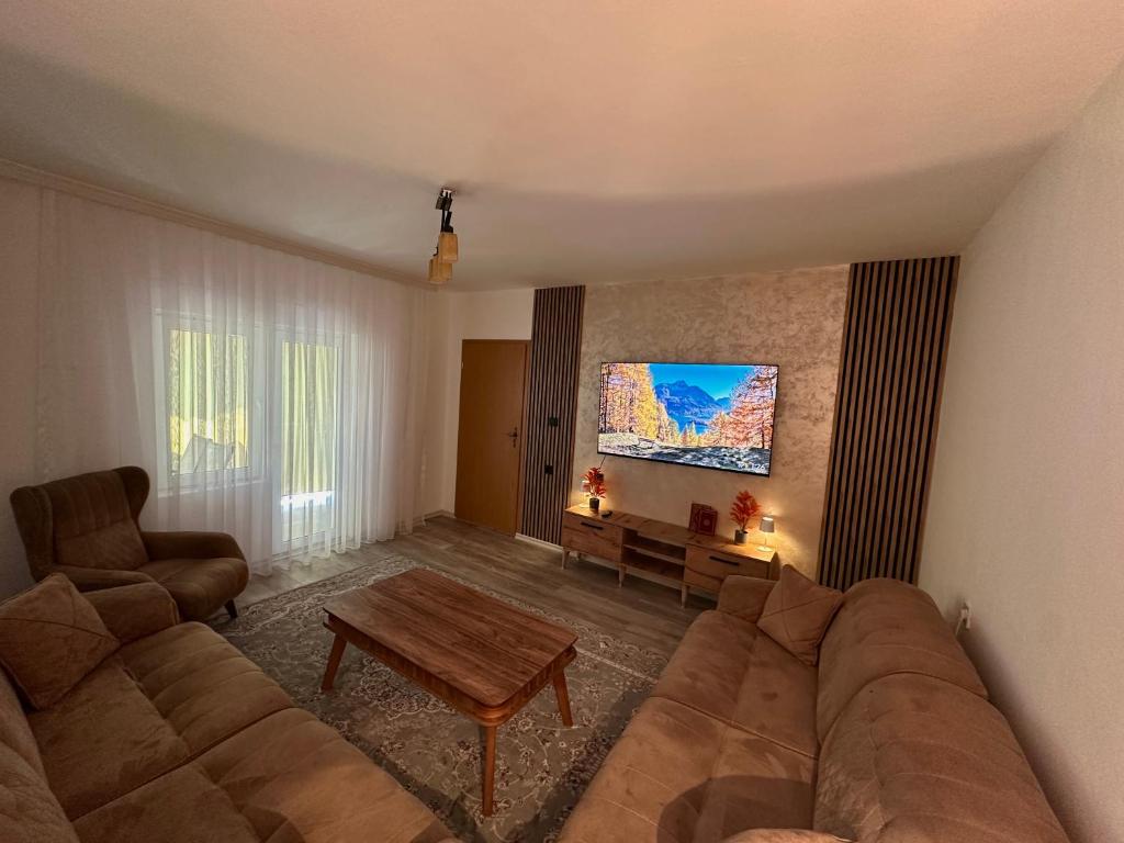 a living room with a couch and a table at Dielli's house in Gnjilane